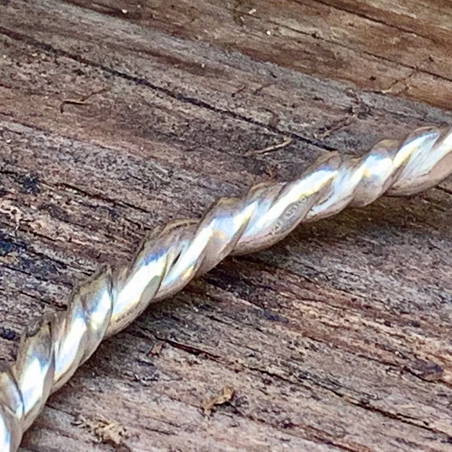 Sterling silver twisted bangle. M/L